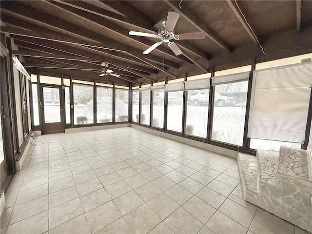 unfurnished sunroom with vaulted ceiling with beams, ceiling fan, wooden ceiling, and a wealth of natural light