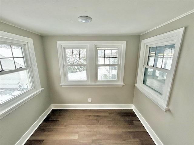 unfurnished room with hardwood / wood-style flooring, a healthy amount of sunlight, and crown molding