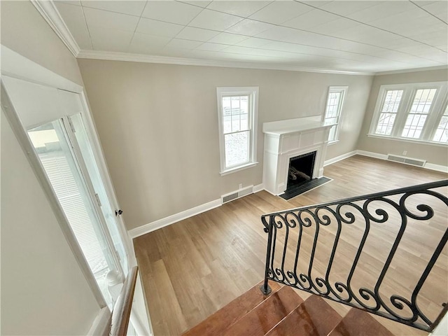 living room with light hardwood / wood-style flooring and ornamental molding