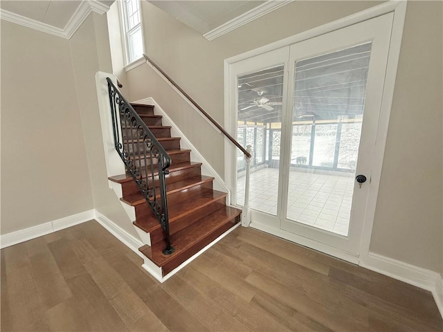 stairway with crown molding and hardwood / wood-style floors