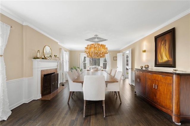 dining space featuring an inviting chandelier, dark wood-type flooring, and ornamental molding