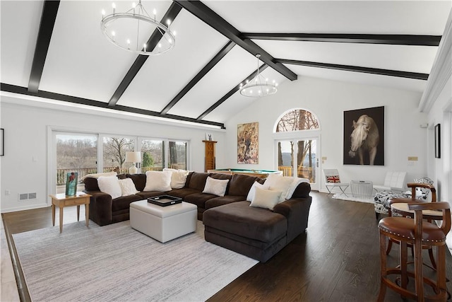 living room featuring beam ceiling, plenty of natural light, a chandelier, and wood-type flooring