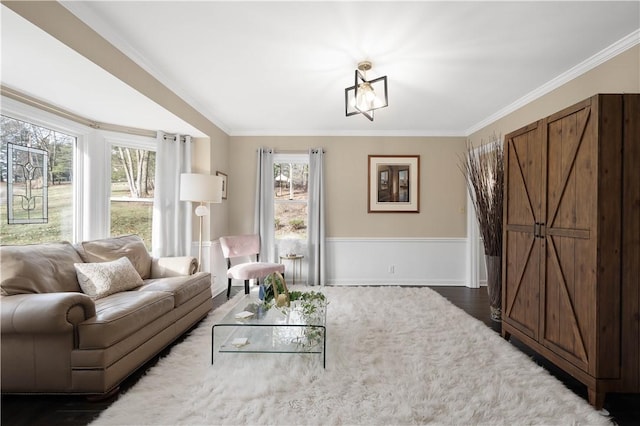 living room with ornamental molding, dark wood-type flooring, and an inviting chandelier