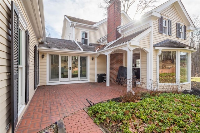 back of property with a patio and french doors