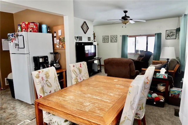 dining space featuring a ceiling fan and tile patterned flooring