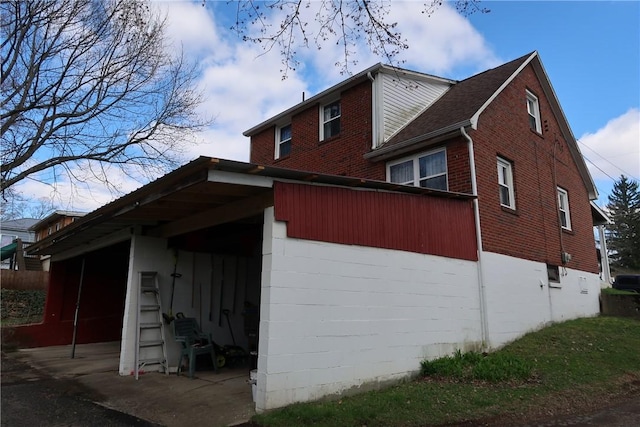 view of property exterior with brick siding