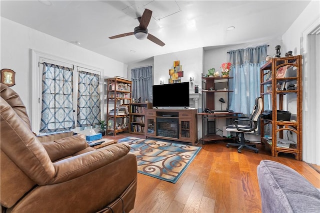 living room with ceiling fan and hardwood / wood-style floors