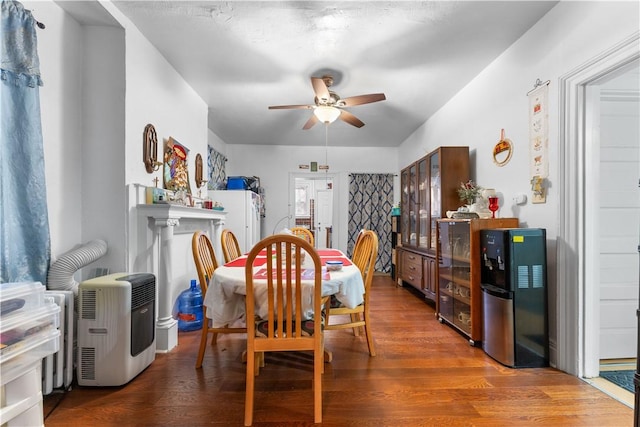 dining space with ceiling fan and dark hardwood / wood-style flooring