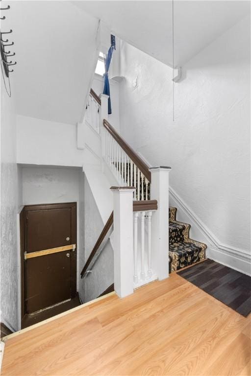 stairs with hardwood / wood-style flooring