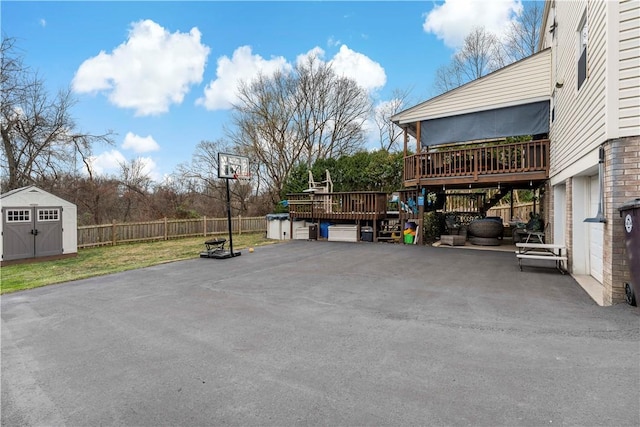 view of patio / terrace featuring a deck and a storage unit