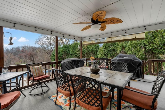 deck featuring area for grilling and ceiling fan