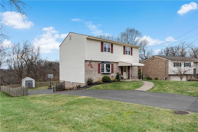 front of property with a shed and a front lawn