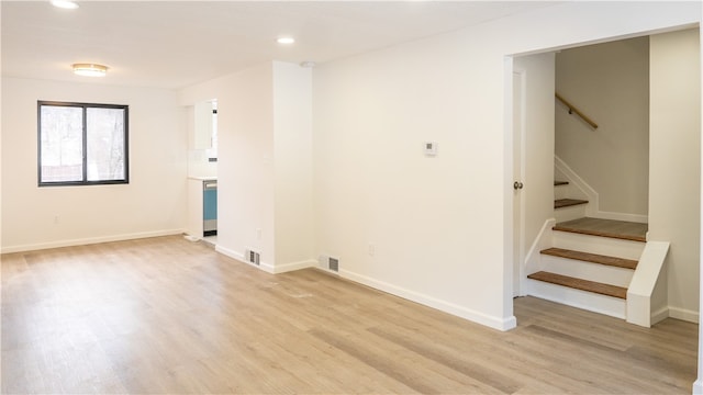 clothes washing area with light hardwood / wood-style flooring