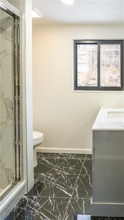 bathroom featuring an enclosed shower, vanity, and toilet