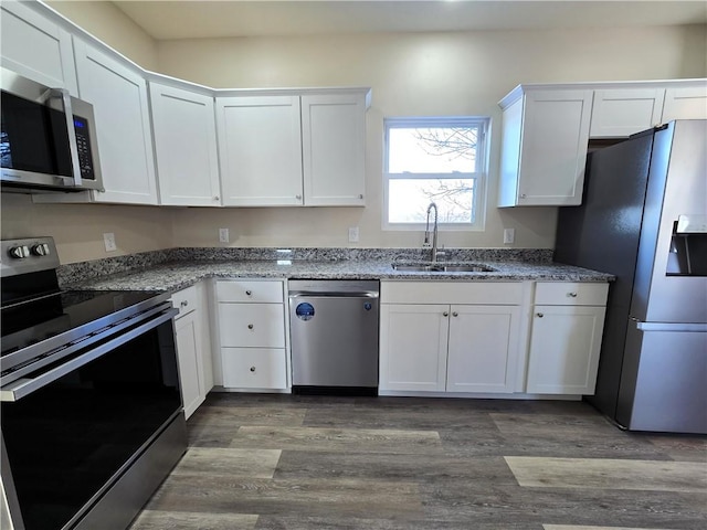 kitchen featuring sink, light stone countertops, white cabinets, and appliances with stainless steel finishes