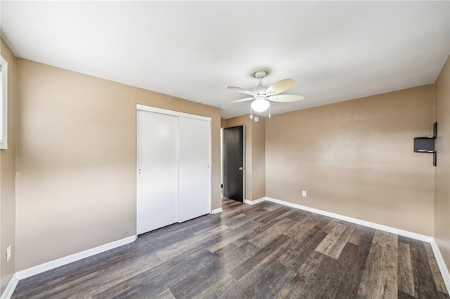 unfurnished bedroom featuring ceiling fan, dark hardwood / wood-style floors, and a closet