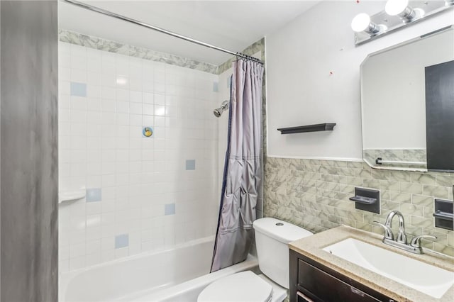 full bathroom with vanity, toilet, tile walls, tasteful backsplash, and shower / tub combo