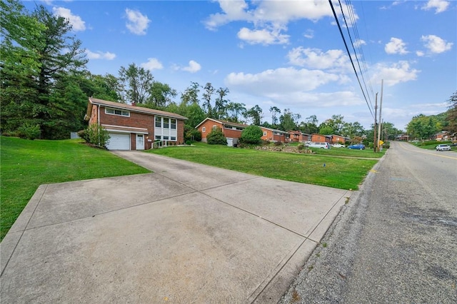 view of front of home featuring a front yard and a garage