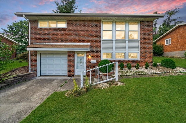 view of front of home with a yard and a garage