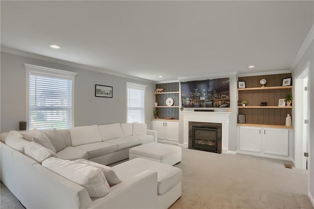 carpeted living room featuring ornamental molding