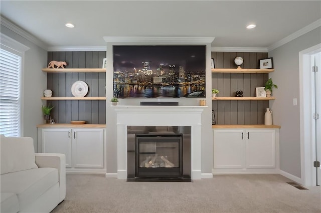 unfurnished living room featuring light carpet and ornamental molding