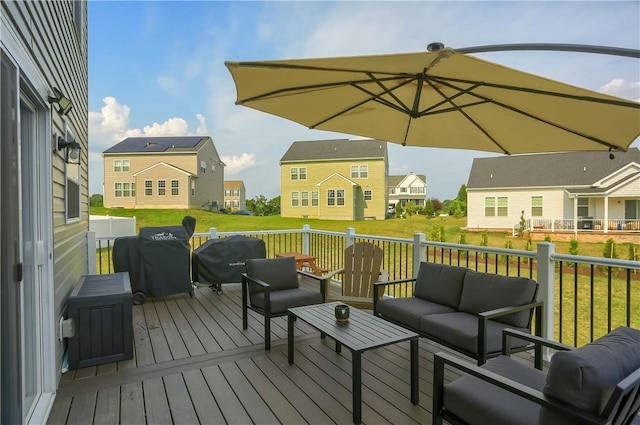 deck featuring outdoor lounge area, grilling area, and a lawn