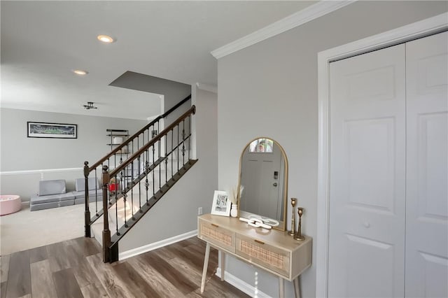 stairs featuring hardwood / wood-style floors and ornamental molding