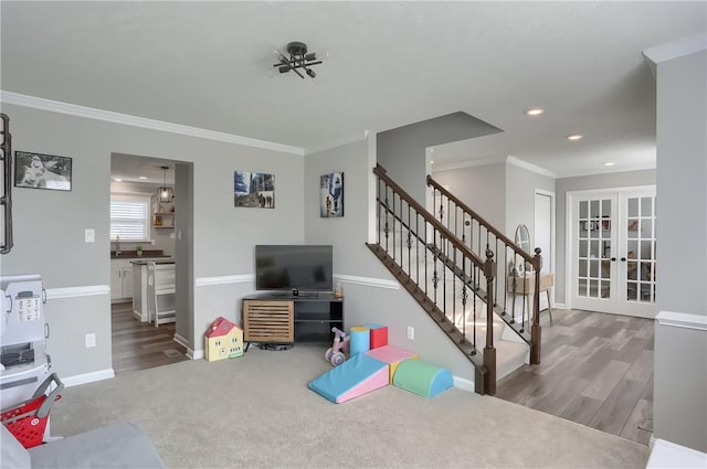 living room with crown molding, french doors, and hardwood / wood-style floors