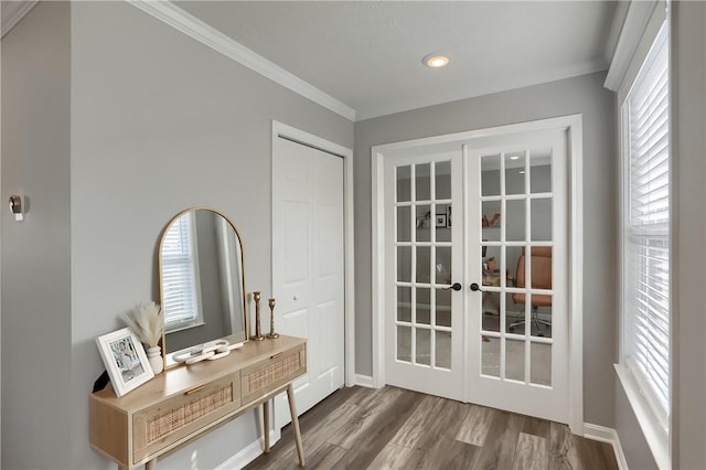 doorway with hardwood / wood-style flooring, crown molding, and french doors