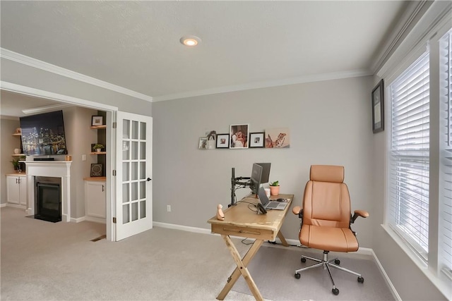 carpeted home office featuring ornamental molding and a wealth of natural light