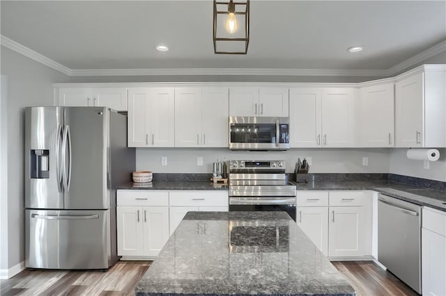 kitchen featuring dark stone counters, a kitchen island, and stainless steel appliances