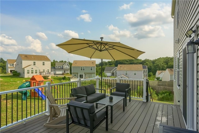 wooden terrace featuring a playground, a yard, and an outdoor hangout area