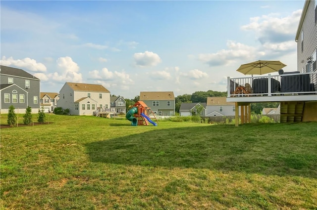 view of yard featuring a playground and a deck