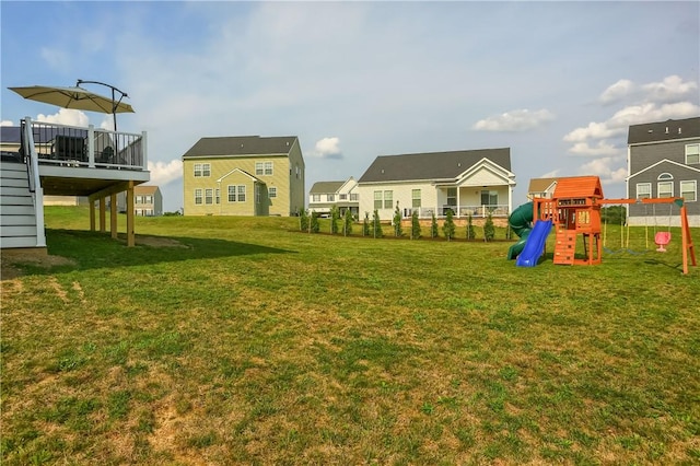 view of yard with a playground and a deck