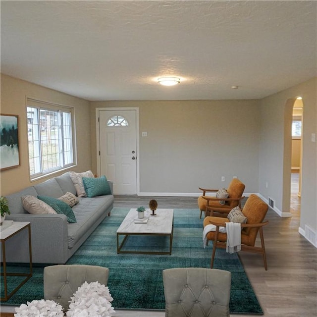 living room featuring a textured ceiling and hardwood / wood-style flooring