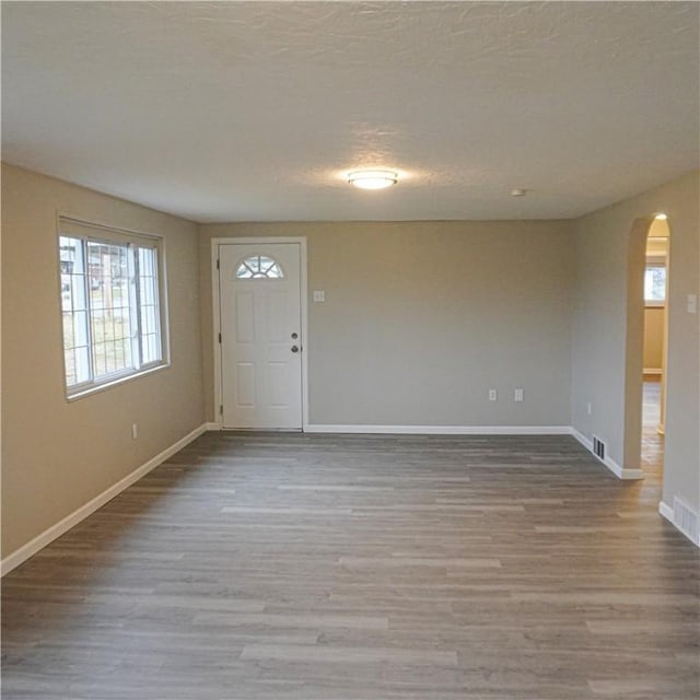 entryway featuring hardwood / wood-style floors and a textured ceiling