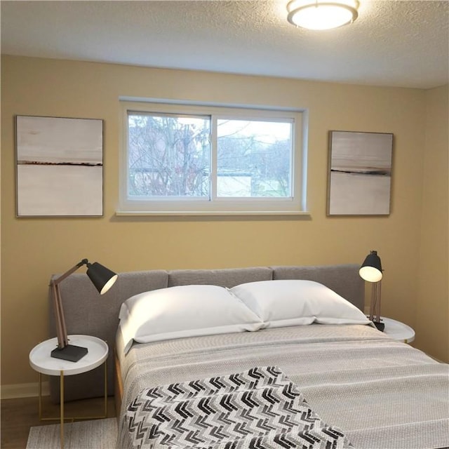 bedroom featuring hardwood / wood-style flooring and a textured ceiling