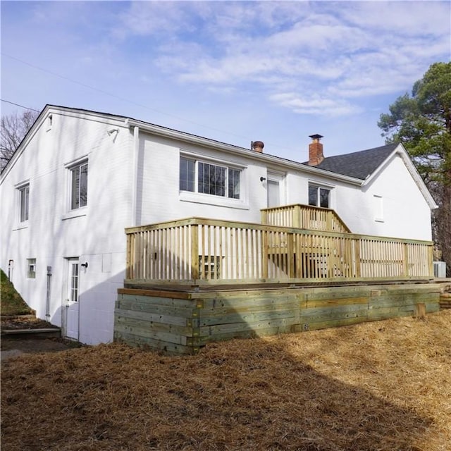 back of house featuring a wooden deck