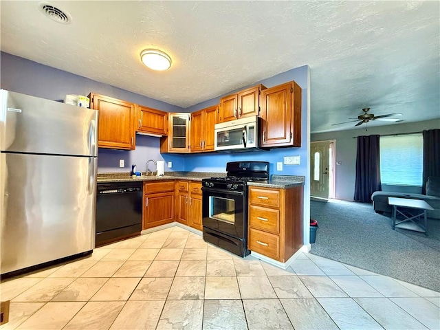 kitchen with sink, light colored carpet, ceiling fan, and black appliances