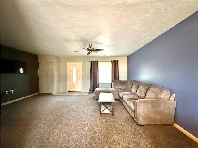 living room with carpet, ceiling fan, and a textured ceiling