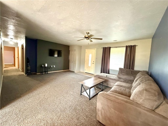 living room with carpet flooring, a textured ceiling, and ceiling fan