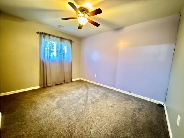 unfurnished room featuring ceiling fan and dark carpet