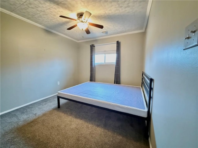 unfurnished bedroom featuring ceiling fan, crown molding, and carpet floors