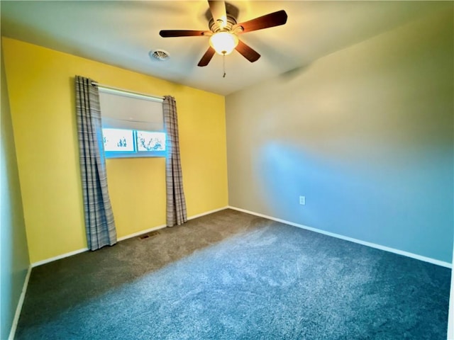 carpeted spare room featuring ceiling fan