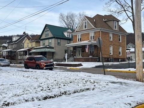 view of snow covered back of property