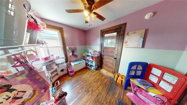 rec room with ceiling fan and dark hardwood / wood-style flooring