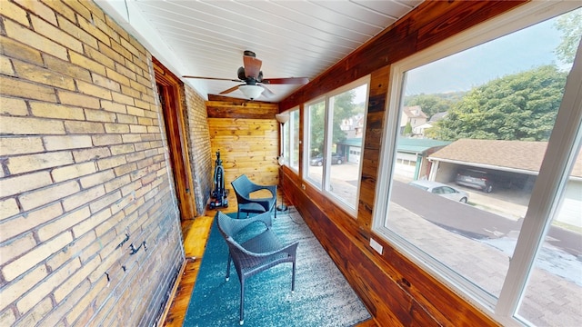 sunroom featuring ceiling fan