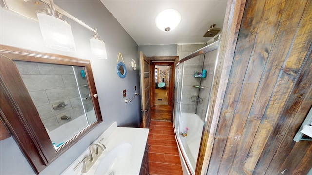 bathroom with vanity and bath / shower combo with glass door