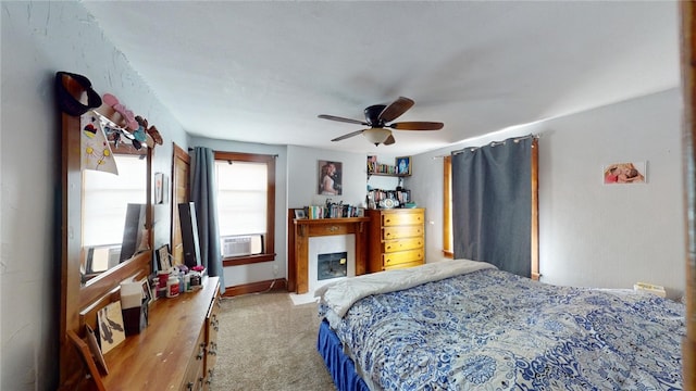 bedroom with ceiling fan, cooling unit, and light colored carpet