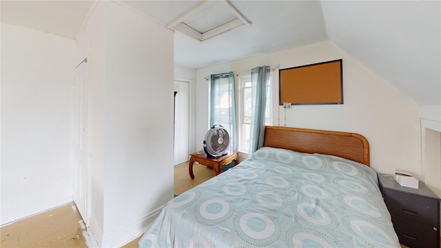 bedroom featuring lofted ceiling and hardwood / wood-style flooring